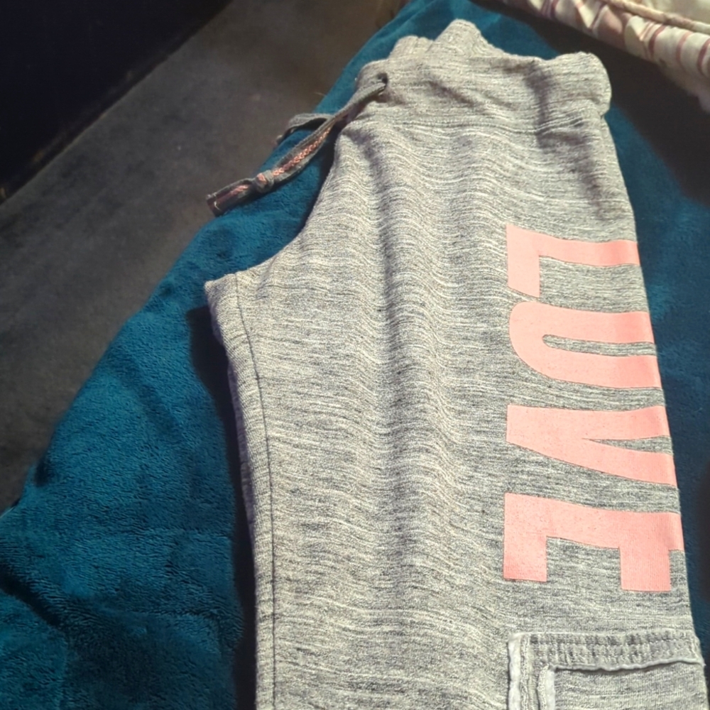 Grey sweats with the word LOVE on them